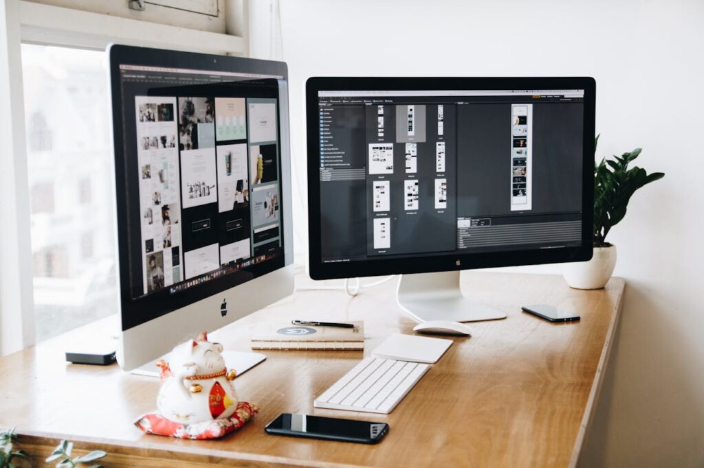 pexels photo 326503 A well-organized design workspace with dual monitors and design software on display.