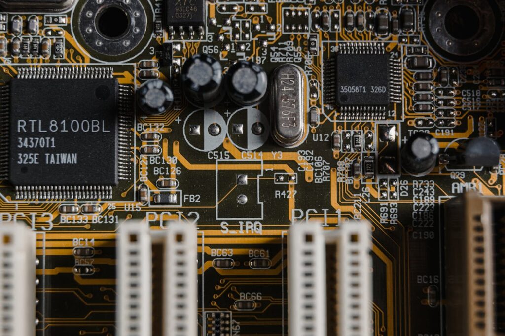 pexels photo 6755078 Detailed view of a motherboard with visible microchips and circuits.
